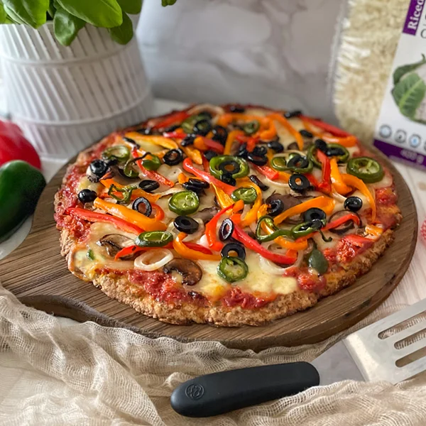 Cauliflower Pizza topped with cheese and veggies