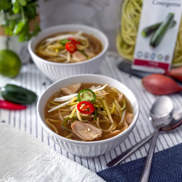 Zucchini spirals with broth and bean sprouts topped with Jalapeno